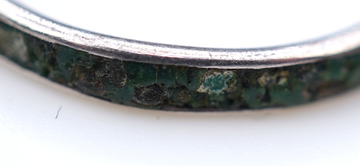 A collection of silver jewels, comprising: a bangle; a chain necklace suspending two winding toothpicks, one with toothpick deficient; a rope twist chain; a pair of cufflinks with the initials DBH; a pendant of abstract